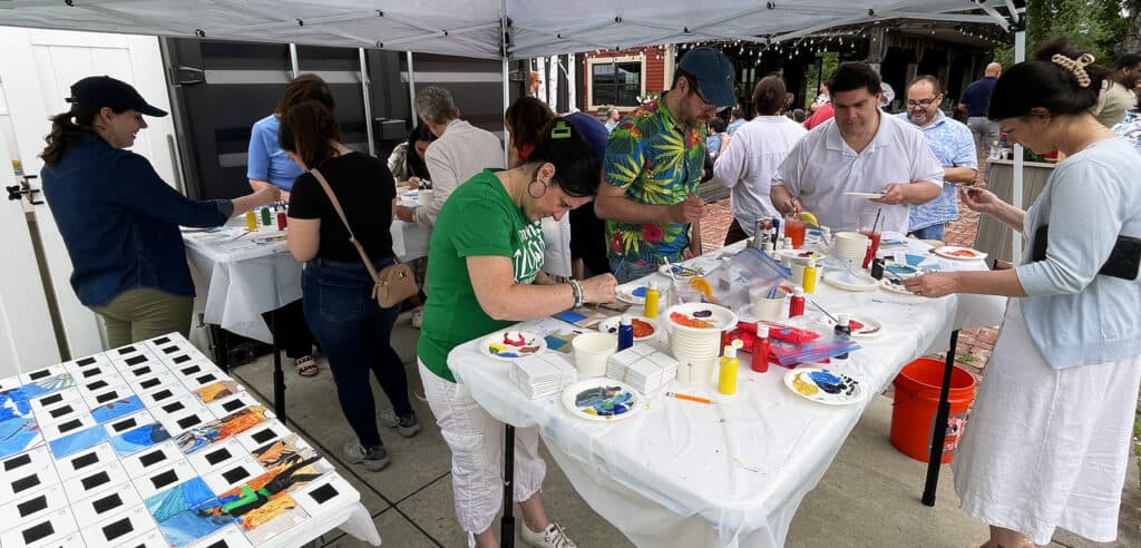 Polaris Direct Team members work on mosaic mural project