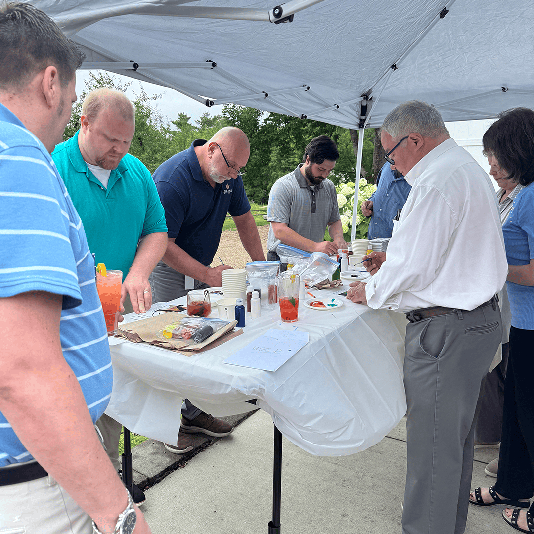 Polaris Direct team members work on mosaic mural project